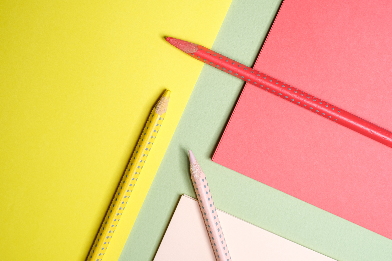 Multicolored Paper and Pencils Flatlay